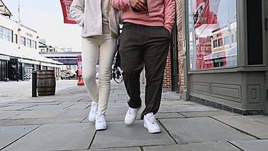 a couple wearing white shoes