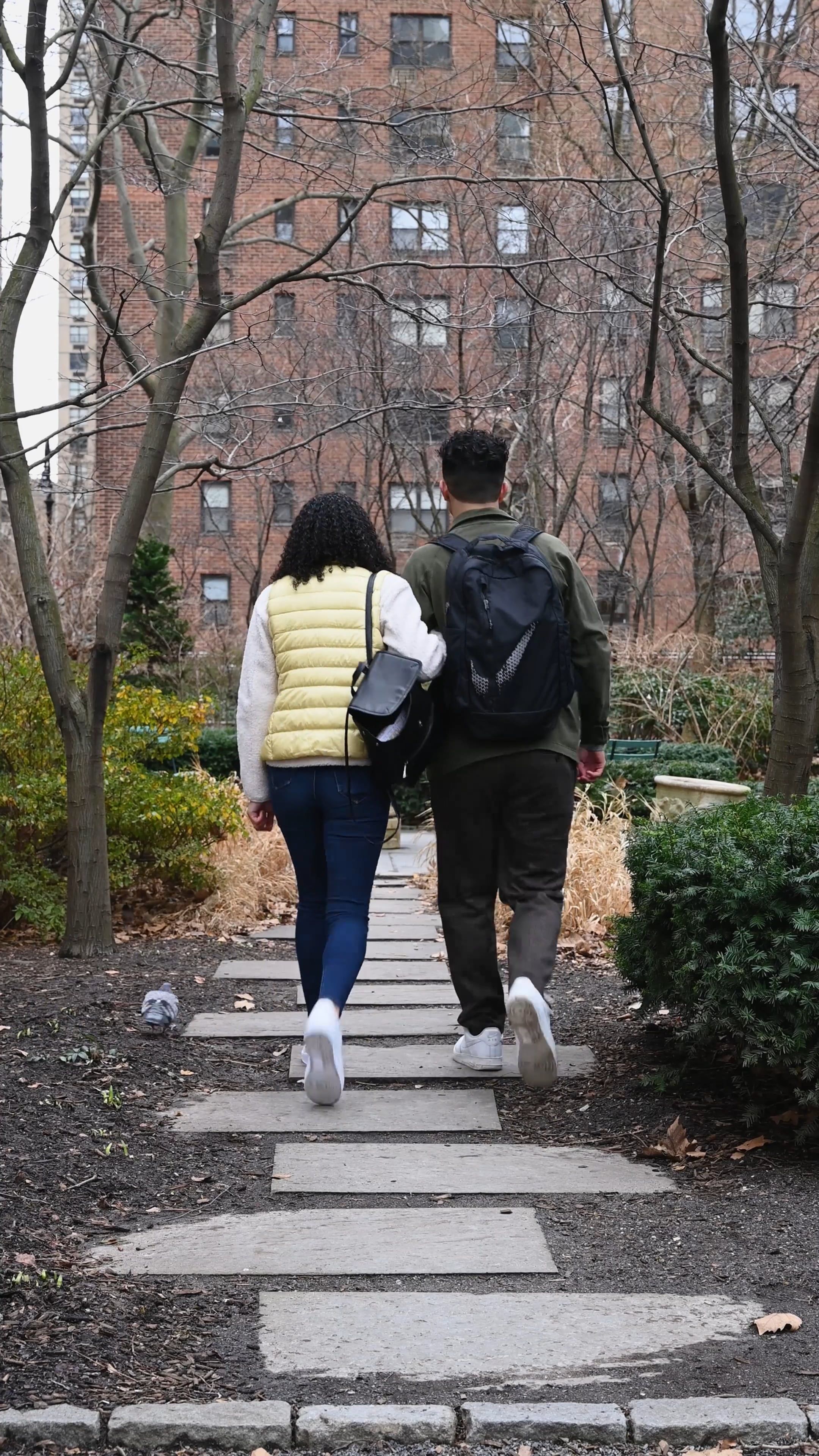 Back View of Young Couple Walking Together in Park · Free Stock Video