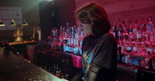 Woman Standing in the Bar Counter