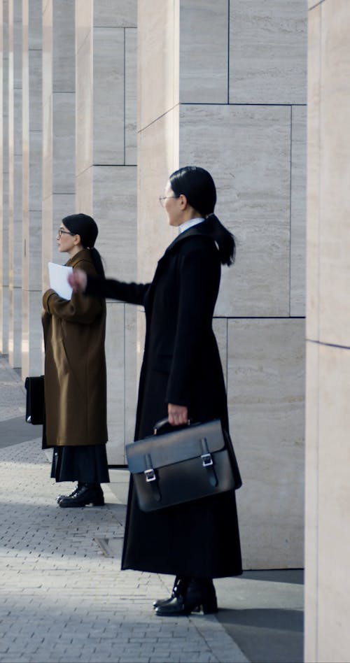 Women In Corporate Attire Standing Outside Building