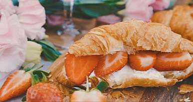 a croissant filled with fresh strawberries and buttercream