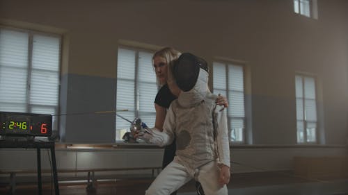 A Woman Instructing the Fencer on how to Use the Sword on Fencing