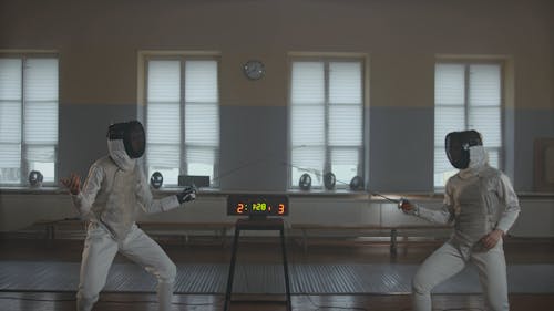 Two Fencers Practicing Techniques in Duel at Fencing Sparring