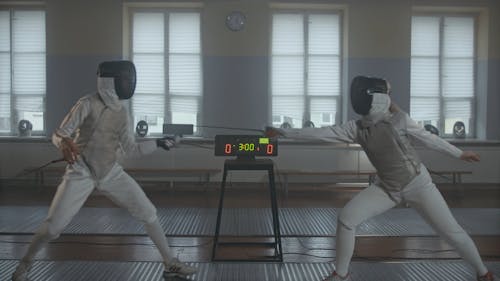Two Fencer Practicing Fencing Wearing Their Protective Suit