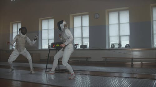 People Fencing Indoors