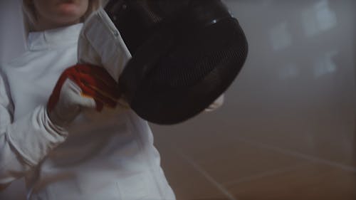 Woman Gearing Up for Fencing Match