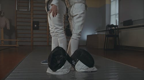 Side View Of Young Girls In Fencing Gear