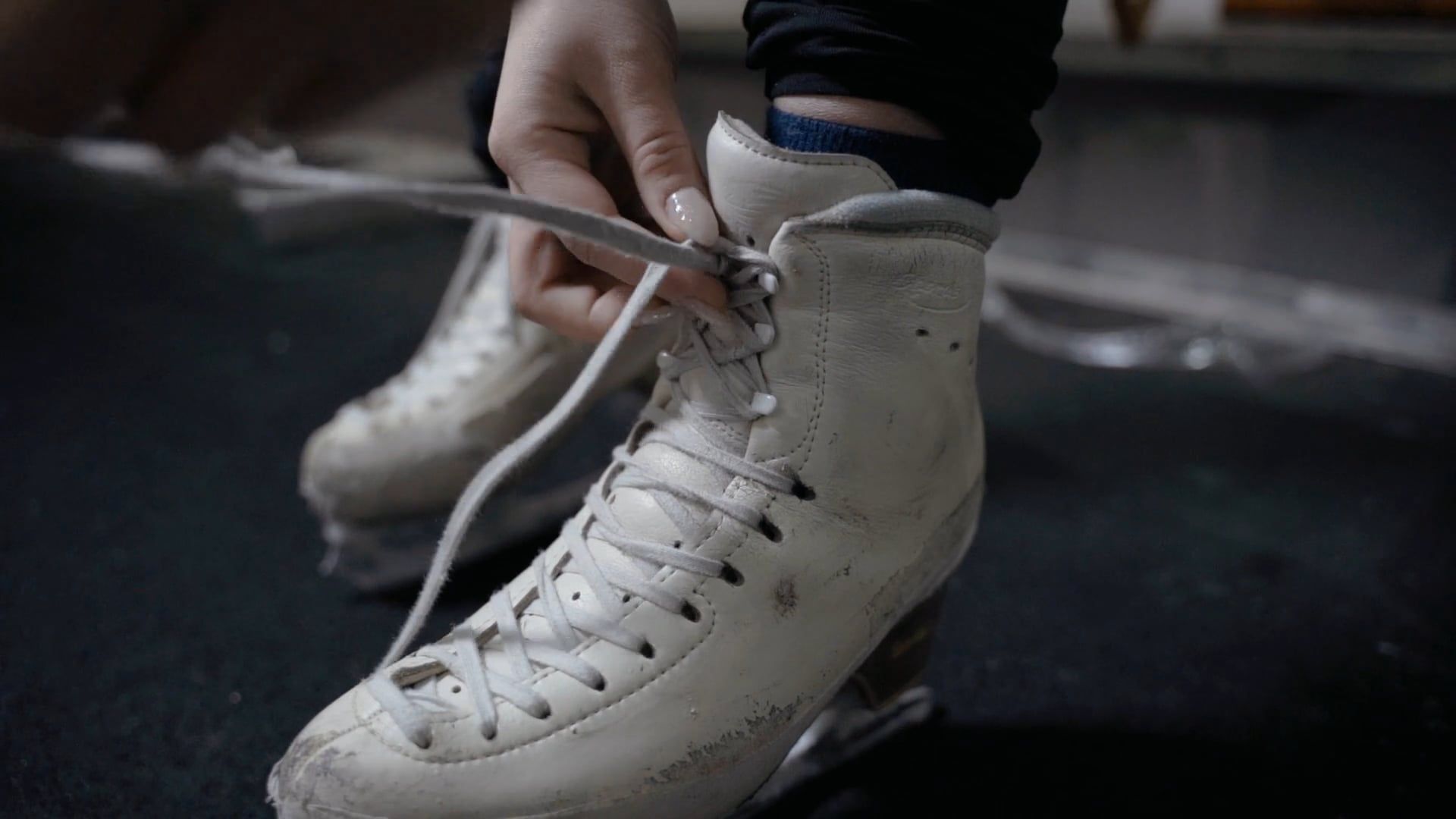 A Person Fixing Shoelaces of an Ice Skating Shoes Free Stock Video ...