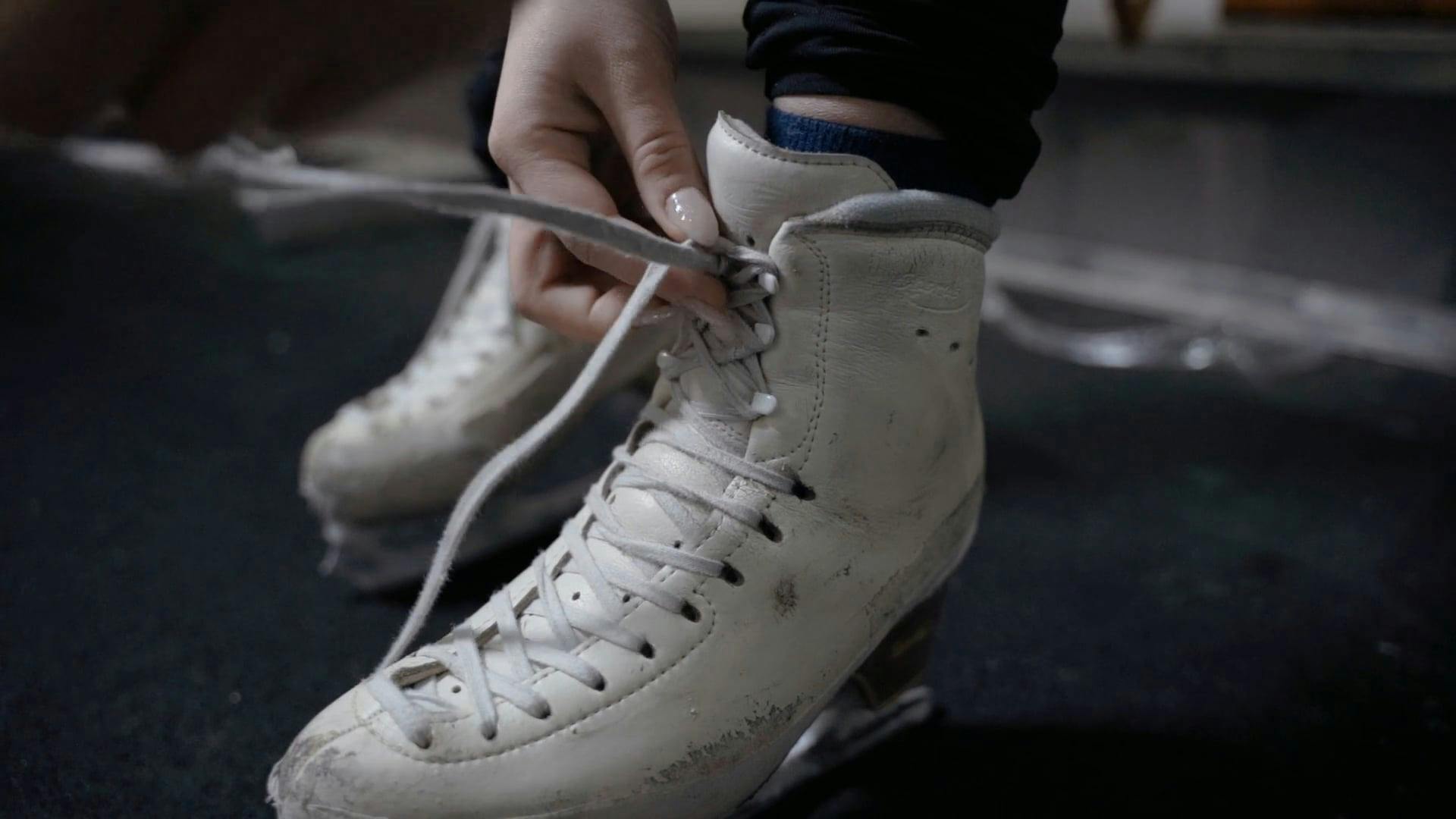 A Person Fixing Shoelaces of an Ice Skating Shoes · Free Stock Video