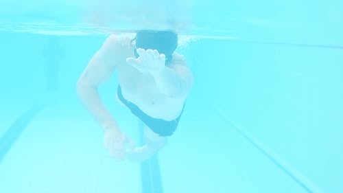 A Man Swimming in the Pool