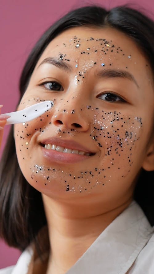 A Woman Applying a Face Mask