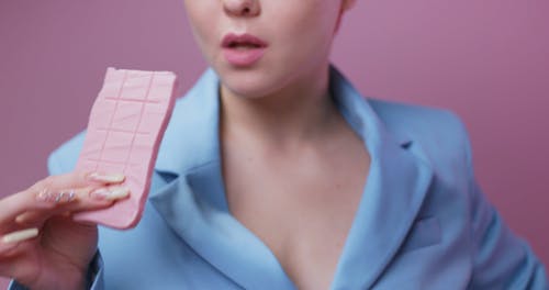 Woman Taking a Bite of Chocolate