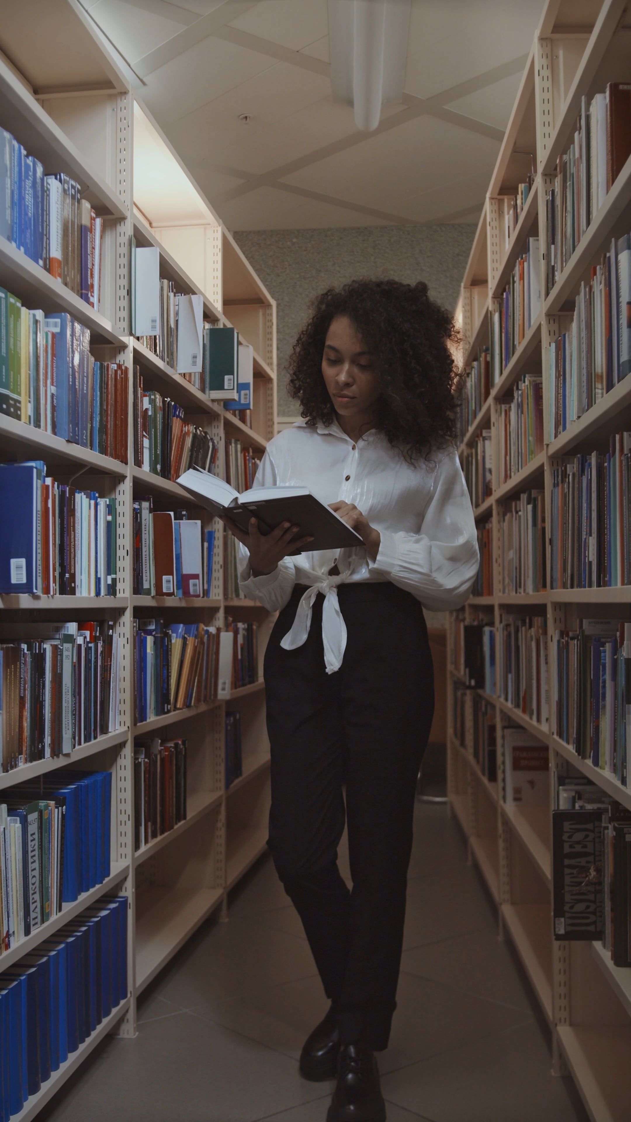 Woman Reading a Book in the Library · Free Stock Video