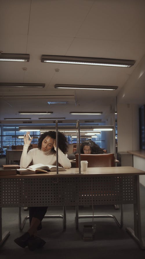 College Students Researching and Reading at the Library