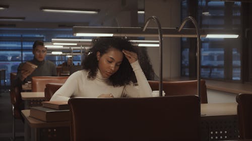 College Students Researching and Reading at the Library