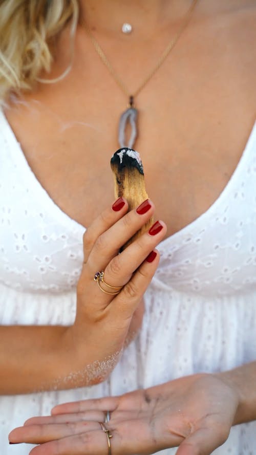 Female Hands Holding Burning Palo Santo Stick