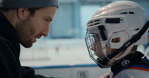 Man Talking to Boy Before Hockey Game