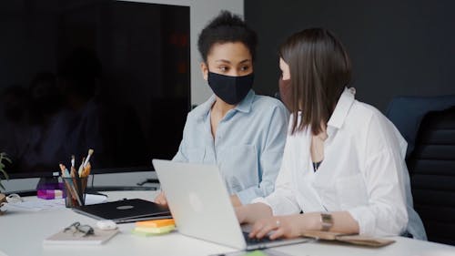 Women Wearing Face Mask Using a Laptop