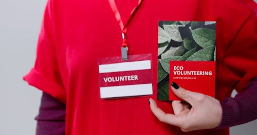 A Volunteer Holding a Brochure