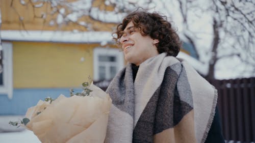 Man Giving Bouquet of Flowers to Woman