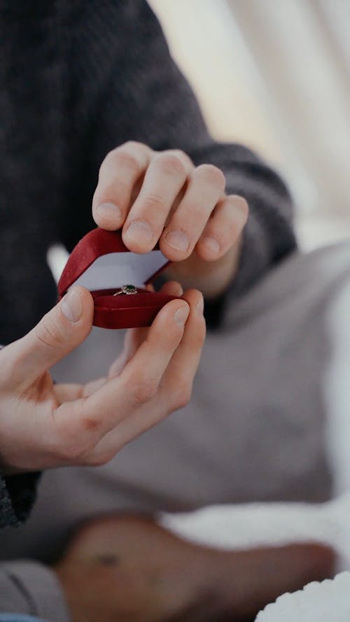 A Person Holding a Ring Box