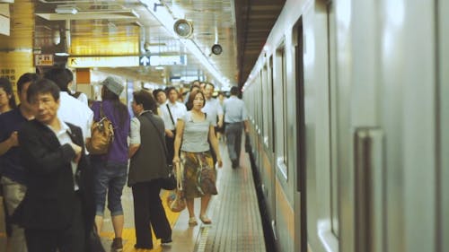 People Getting Ready to Board the Subway Train