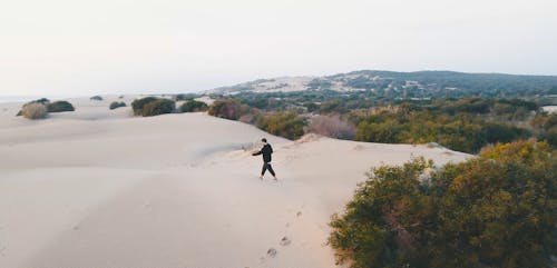 Person Walking on Sand Dunes