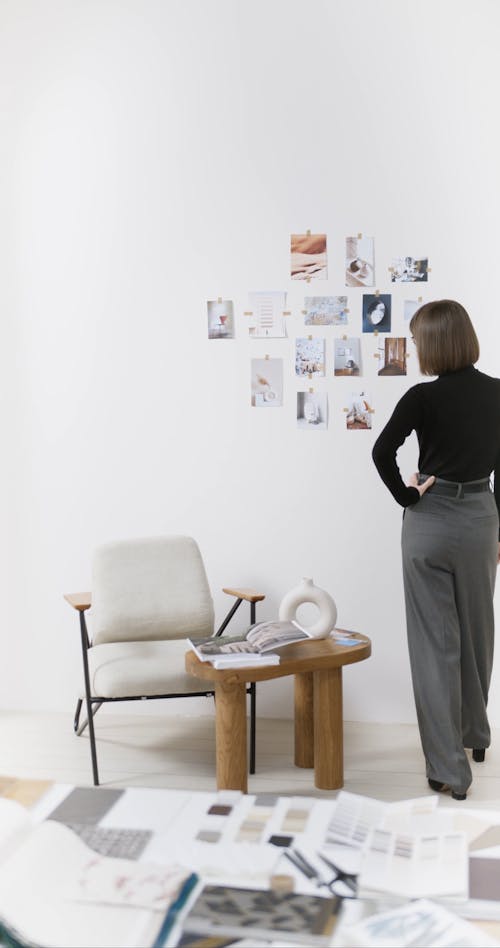 A Woman Pasting Pictures on the Wall
