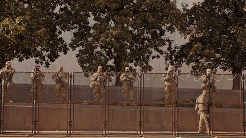 Wall of Soldiers Carrying Guns