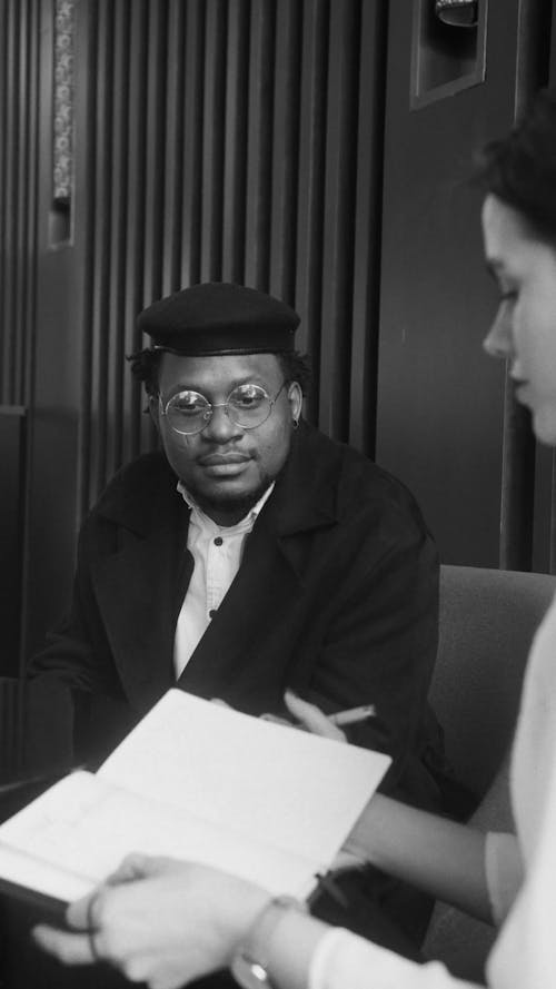 Black and White Footage of a Man Talking to a Woman