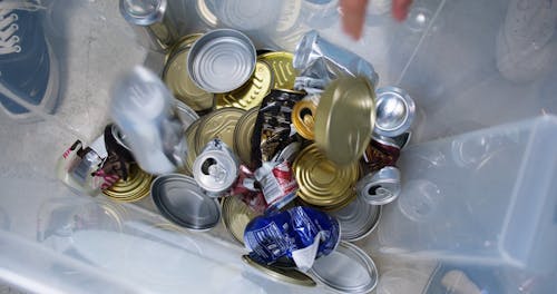 Dropping Cans into the Container