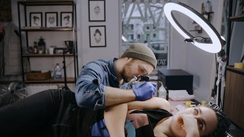 A Man Tattooing
