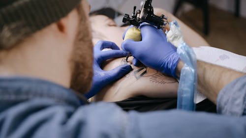 A Man Tattooing