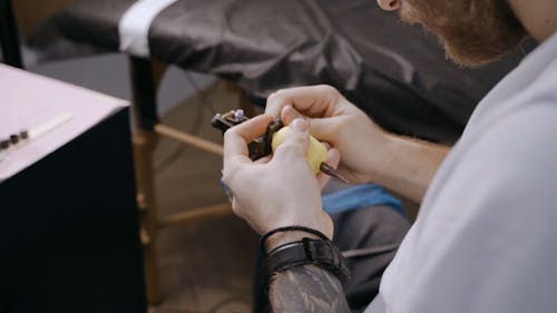 Man holding Tattoo Machine