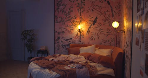 A Boy Jumping on the Bed and Looking at the Magazine and Photos