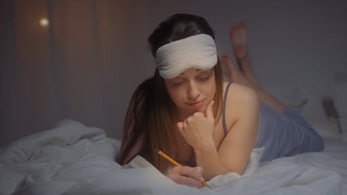 Woman Reading a Book at Bedtime