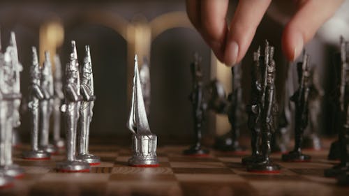 Close-up Footage of People Moving a Chess Pieces