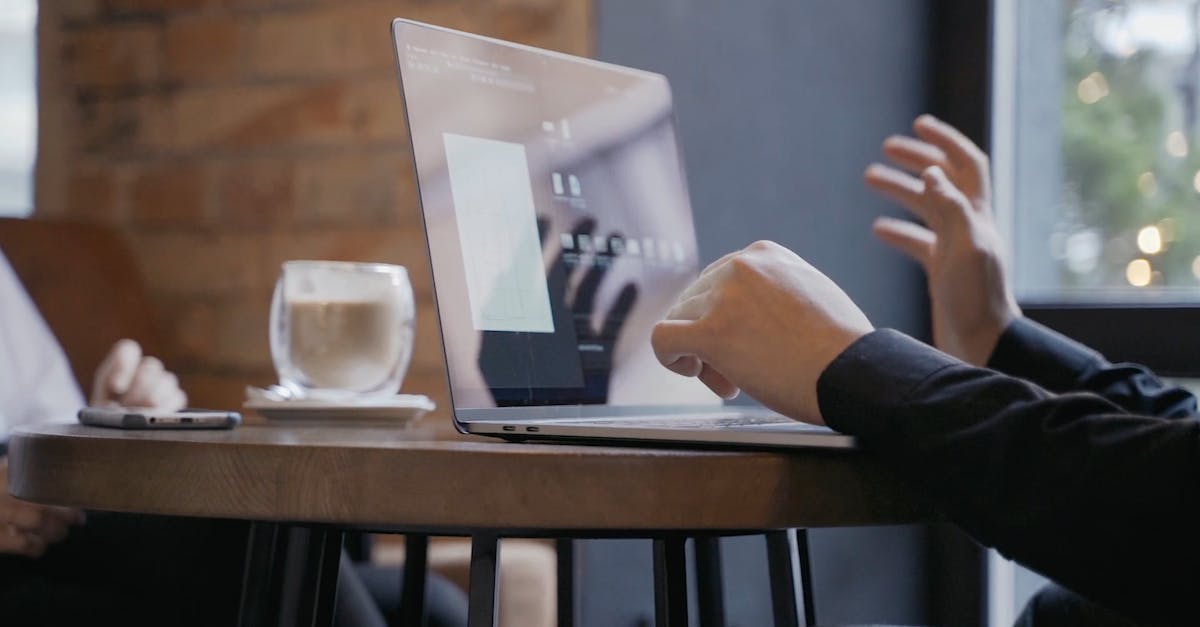 Close-up Footage of a Laptop and Cellphone on a Wooden Table Free Stock ...