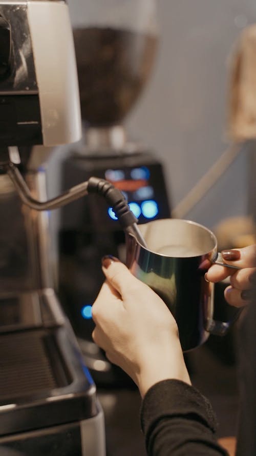 A Barista Using a Coffee Machine