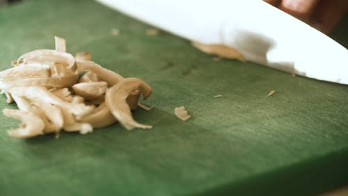 A Person Slicing Mushroom