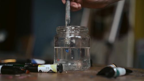 Close-Up View of Person Holding a Paintbrush