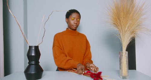 Person Placing Flowers on a Vase