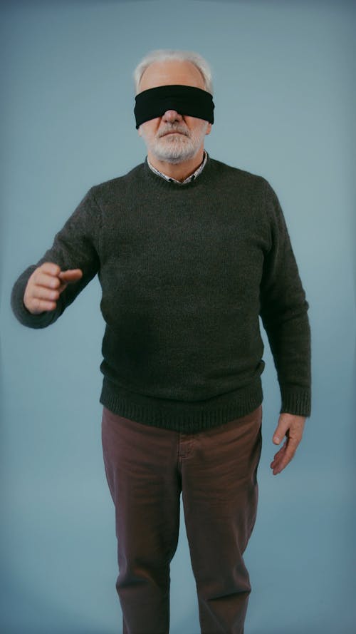 Elderly Man Removing Blindfold