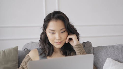 Woman on the Couch Looking at Computer