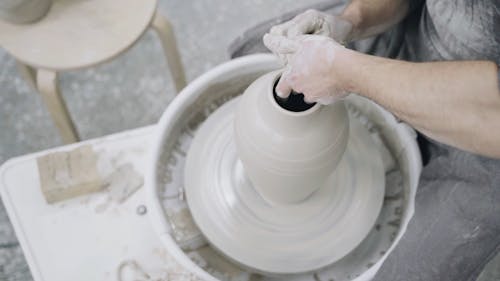 Man Using a Pottery Wheel to Create a Clay Vase