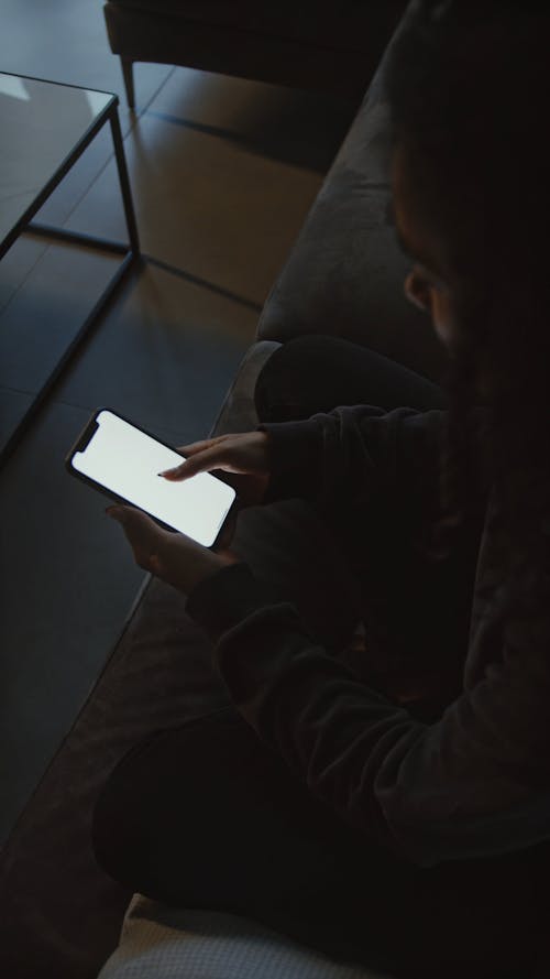 High-Angle Shot of a Person Using a Smartphone