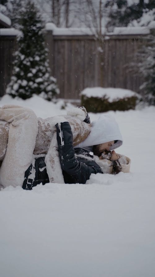 Video of a Couple Kissing while Lying on the Snow