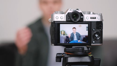 A Man Video Recording Himself Using a Camera