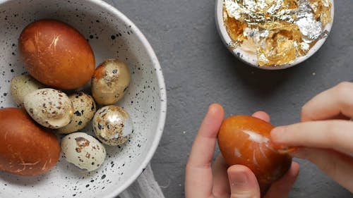 Person Decorating Eggs