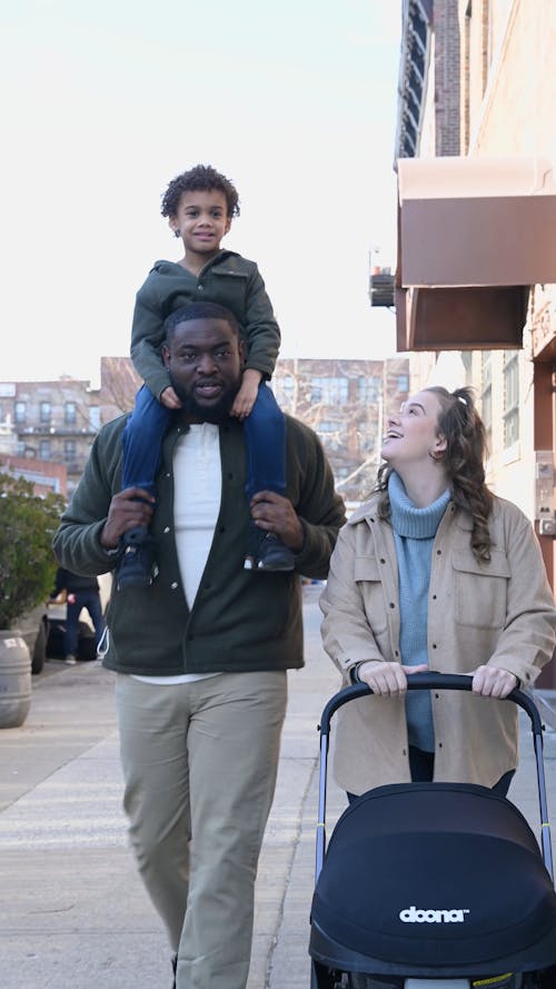 Happy Family Strolling on Street